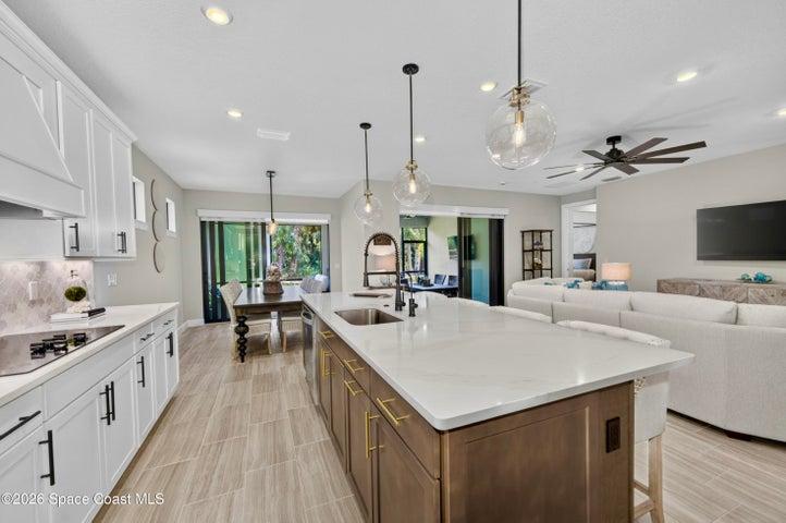 Gourmet Kitchen: Level 5 Calcutta Gold quartz countertops, Level 5 marble fish scale fan-shape backsplash, Level 4 white wood cabinetry, Contrasting Level 4 wood-tone island cabinetry creating a custom two-tone desinger kitchen, Microwave/Wall oven, LG 4 DOOR REFRIGERATOR featuring: InstaView Door-in-Door, Craft ice maker, Convertible fridge/freezer drawer and CUSTOM BUTLER PANTRY