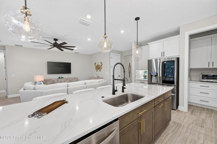 Gourmet Kitchen: Level 5 Calcutta Gold quartz countertops, Level 5 marble fish scale fan-shape backsplash, Level 4 white wood cabinetry, Contrasting Level 4 wood-tone island cabinetry creating a custom two-tone desinger kitchen, Microwave/Wall oven, LG 4 DOOR REFRIGERATOR featuring: InstaView Door-in-Door, Craft ice maker, Convertible fridge/freezer drawer and CUSTOM BUTLER PANTRY