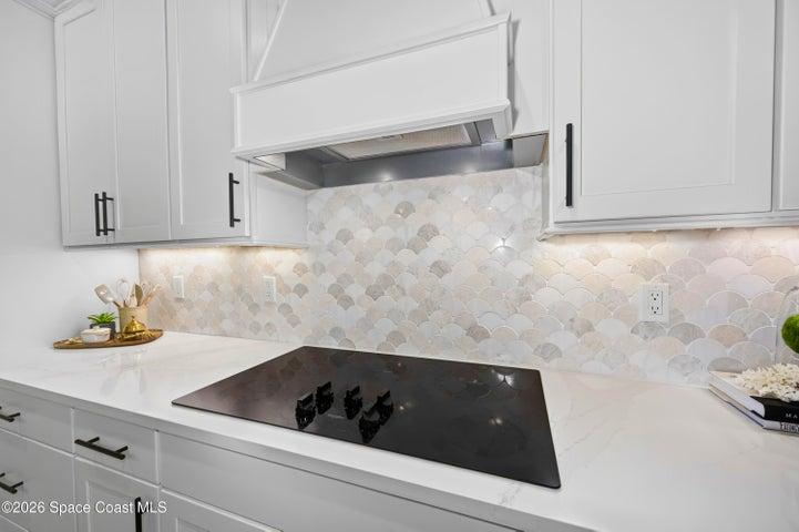Gourmet Kitchen: Level 5 Calcutta Gold quartz countertops, Level 5 marble fish scale fan-shape backsplash, Level 4 white wood cabinetry, Contrasting Level 4 wood-tone island cabinetry creating a custom two-tone desinger kitchen, Microwave/Wall oven, LG 4 DOOR REFRIGERATOR featuring: InstaView Door-in-Door, Craft ice maker, Convertible fridge/freezer drawer and CUSTOM BUTLER PANTRY