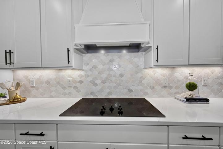 Gourmet Kitchen: Level 5 Calcutta Gold quartz countertops, Level 5 marble fish scale fan-shape backsplash, Level 4 white wood cabinetry, Contrasting Level 4 wood-tone island cabinetry creating a custom two-tone desinger kitchen, Microwave/Wall oven, LG 4 DOOR REFRIGERATOR featuring: InstaView Door-in-Door, Craft ice maker, Convertible fridge/freezer drawer and CUSTOM BUTLER PANTRY