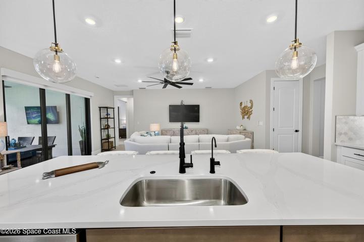 Gourmet Kitchen: Level 5 Calcutta Gold quartz countertops, Level 5 marble fish scale fan-shape backsplash, Level 4 white wood cabinetry, Contrasting Level 4 wood-tone island cabinetry creating a custom two-tone desinger kitchen, Microwave/Wall oven, LG 4 DOOR REFRIGERATOR featuring: InstaView Door-in-Door, Craft ice maker, Convertible fridge/freezer drawer and CUSTOM BUTLER PANTRY