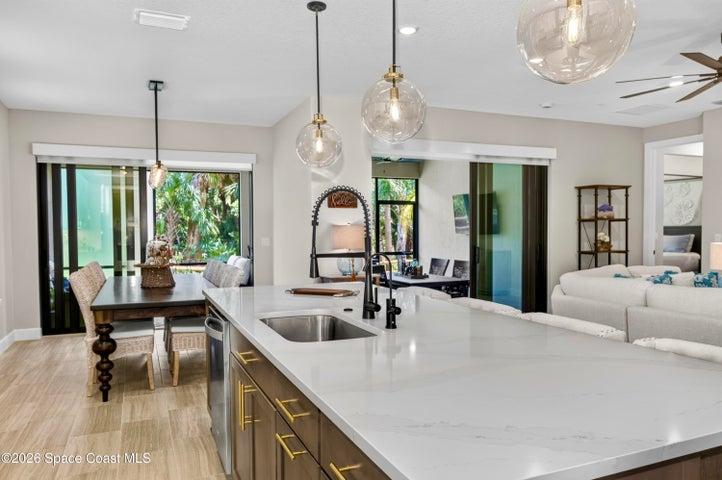 Gourmet Kitchen: Level 5 Calcutta Gold quartz countertops, Level 5 marble fish scale fan-shape backsplash, Level 4 white wood cabinetry, Contrasting Level 4 wood-tone island cabinetry creating a custom two-tone desinger kitchen, Microwave/Wall oven, LG 4 DOOR REFRIGERATOR featuring: InstaView Door-in-Door, Craft ice maker, Convertible fridge/freezer drawer and CUSTOM BUTLER PANTRY