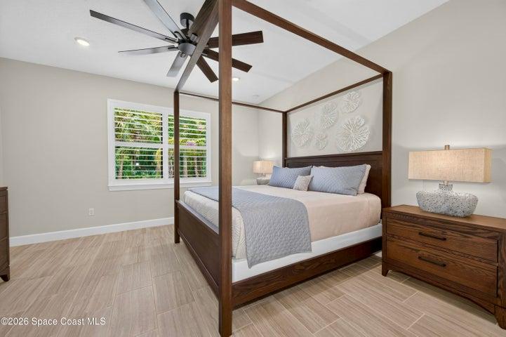BEDROOM SUITE:  Plantation Shutters over large window with views out to preserve. Hunter statement ceiling fan with remotes, LED Lighting, Porcelain tile floor, TWO WALK-IN CLOSETS!