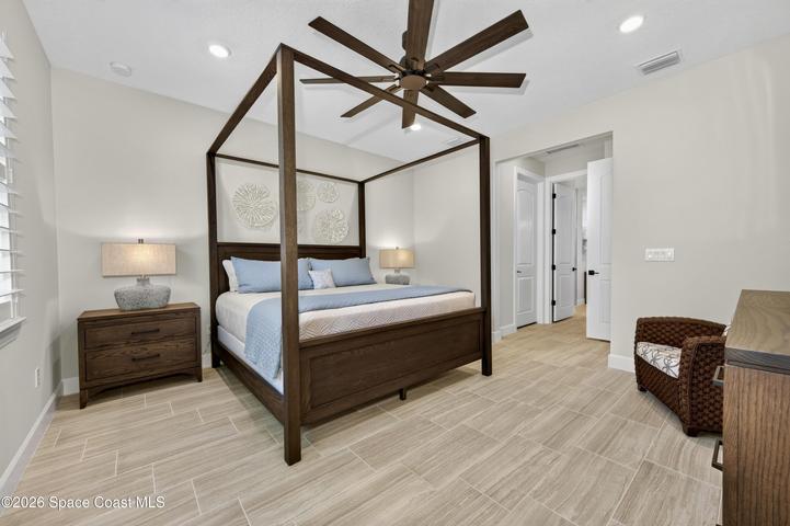BEDROOM SUITE:  Plantation Shutters over large window with views out to preserve. Hunter statement ceiling fan with remotes, LED Lighting, Porcelain tile floor, TWO WALK-IN CLOSETS!