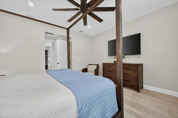 BEDROOM SUITE:  Plantation Shutters over large window with views out to preserve. Hunter statement ceiling fan with remotes, LED Lighting, Porcelain tile floor, TWO WALK-IN CLOSETS!