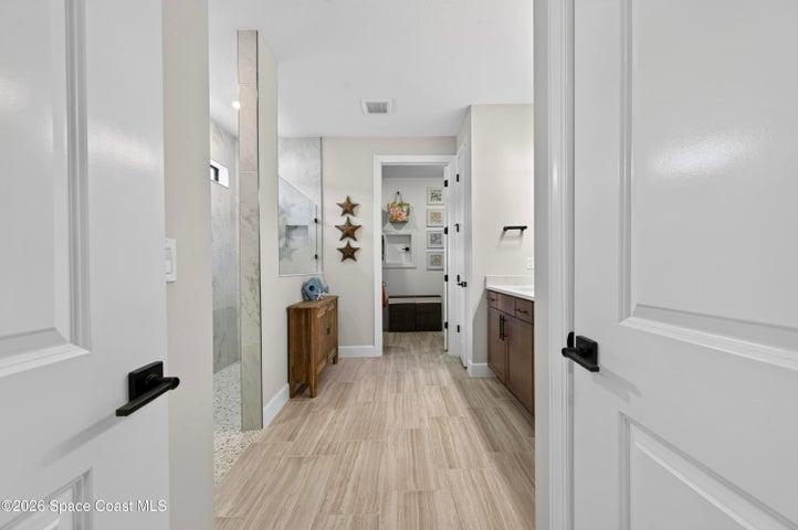 ENSUITE BATHROOM: Level 4 cabinetry with soft close wood doors and drawers, Level 3 quartz vanity countertop, Comfort-Height Kohler toilet, Upgraded sink faucets and shower fixtures, Large Roman shower featuring: transom window for natural light and privacy, floor-to-ceiling Level 5 vertical porcelain tile, Designer vanity lighting, Upgraded double-sink vanity.