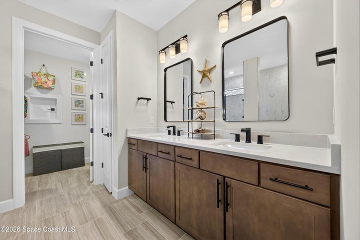 ENSUITE BATHROOM: Level 4 cabinetry with soft close wood doors and drawers, Level 3 quartz vanity countertop, Comfort-Height Kohler toilet, Upgraded sink faucets and shower fixtures, Large Roman shower featuring: transom window for natural light and privacy, floor-to-ceiling Level 5 vertical porcelain tile, Designer vanity lighting, Upgraded double-sink vanity.