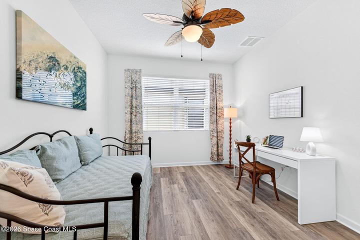 Flexible den or third bedroom with elegant French doors, ideal as a home office.