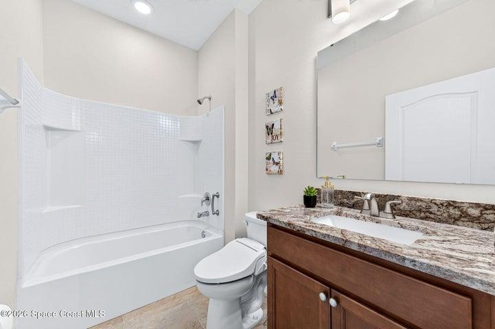 Guest bathroom featuring upgraded granite countertops and bidet