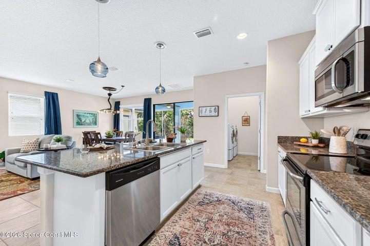 Well placed laundry room adjacent to the kitchen enhances everyday living