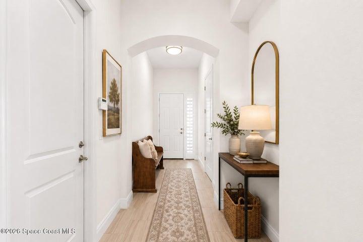 Bright entryway featuring stylish finishes and a spacious hallway