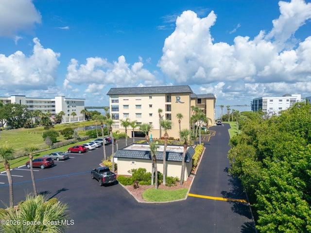 Riverwest condominium building exterior with resident parking — 190 Escambia Lane, Cocoa Beach, FL