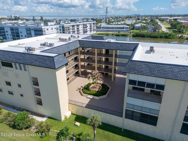 Interior courtyard at Riverwest condo with covered walkways and palm tree garden, Cocoa Beach, Florida