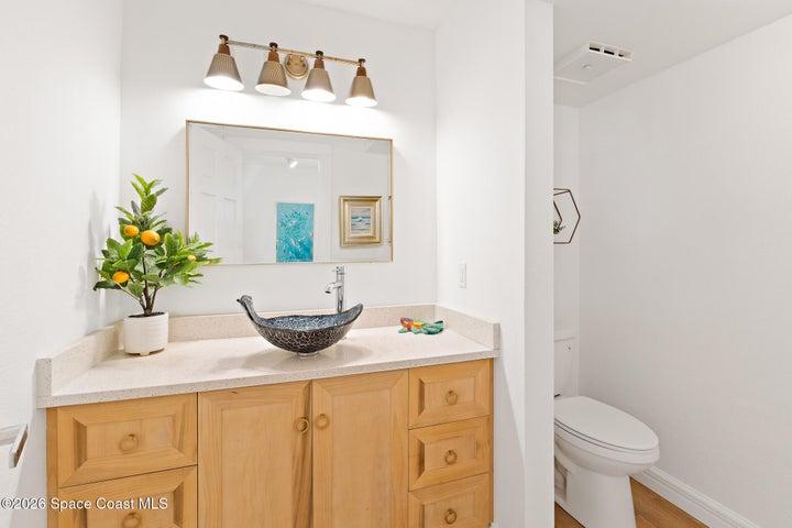 Powder bathroom with mosaic glass vessel sink, Quartz vanity — Cocoa Beach condo