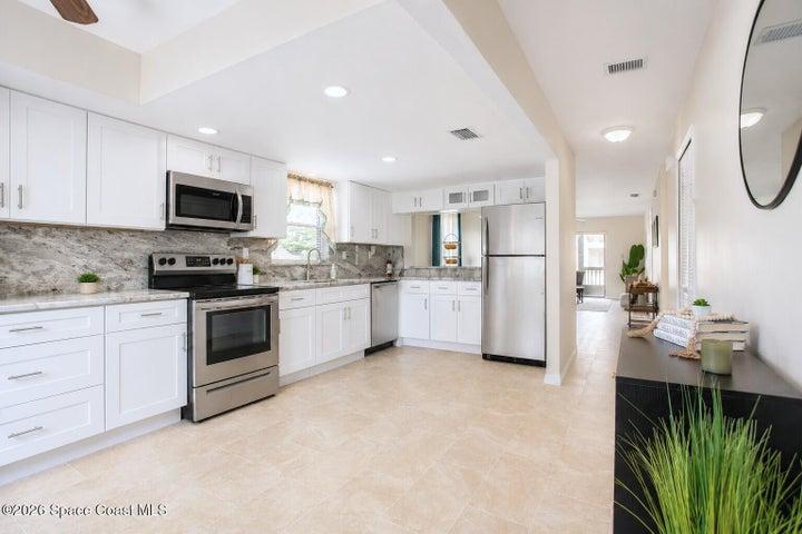 Updated kitchen with granite countertops and continued backsplash