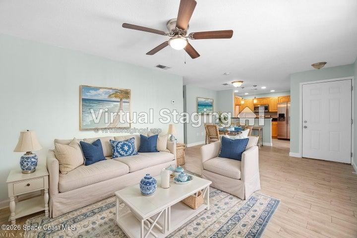 Family room looking into kitchen area. Wood plank tile throughout.