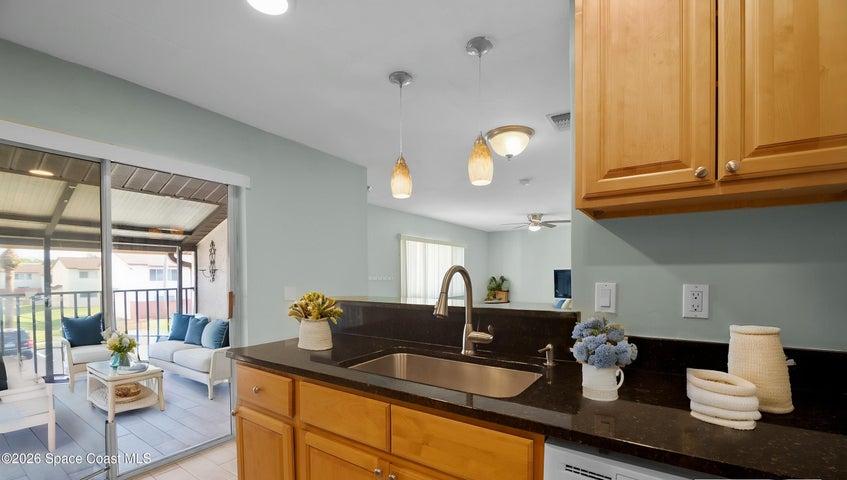 Kitchen, stainless steel appliances, granite top, recessed lighting, wood cabinets, slider to screened patio.