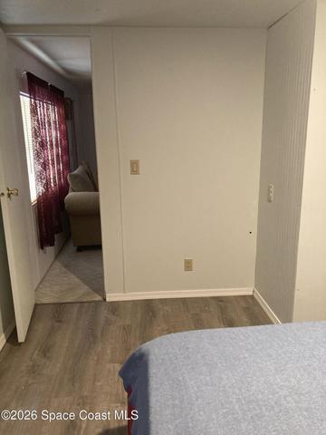 FRONT BEDROOM TO THE LIVING ROOM
