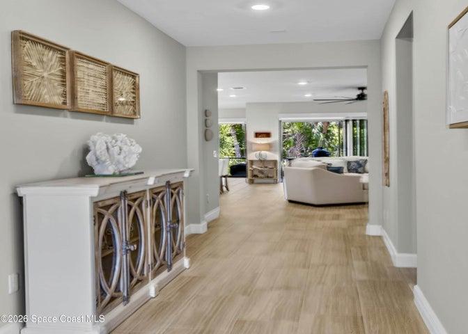 Inviting Wide Foyer - bright from Front glass door.  Foyer opens to guest bedrooms, guest bathrooms, laundry room and Greatroom, Kitchen, Dining area.  Beautiful tropical preserve views welcome you home.