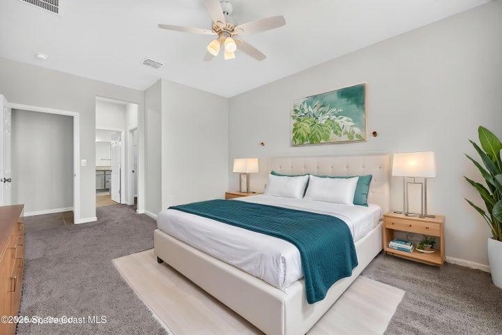 Virtually staged primary bedroom with walk-in and ensuite