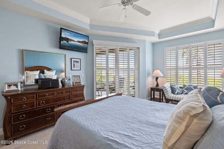 Primary bedroom with access to rear patio overlooking the river
