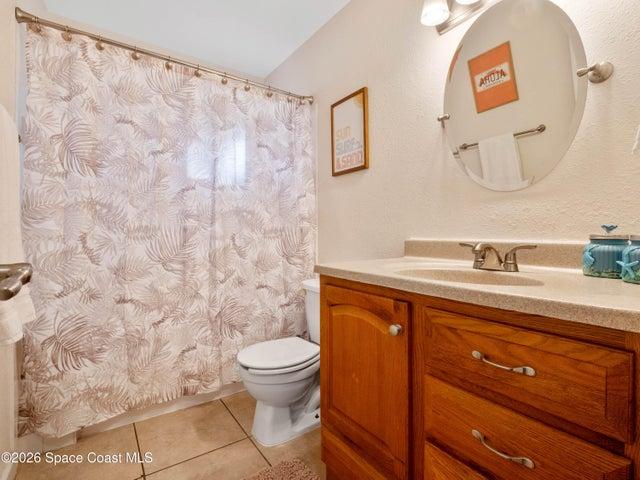 Full bathroom featuring a spacious vanity and shower with tub.
