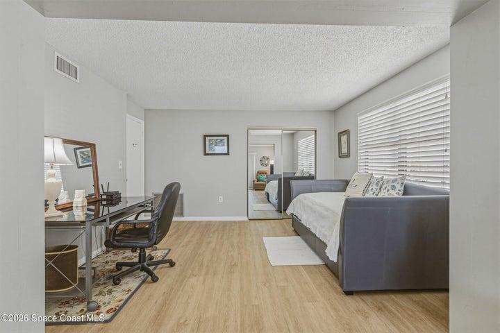 Spacious room with a ocean view from the window and a closet for storage