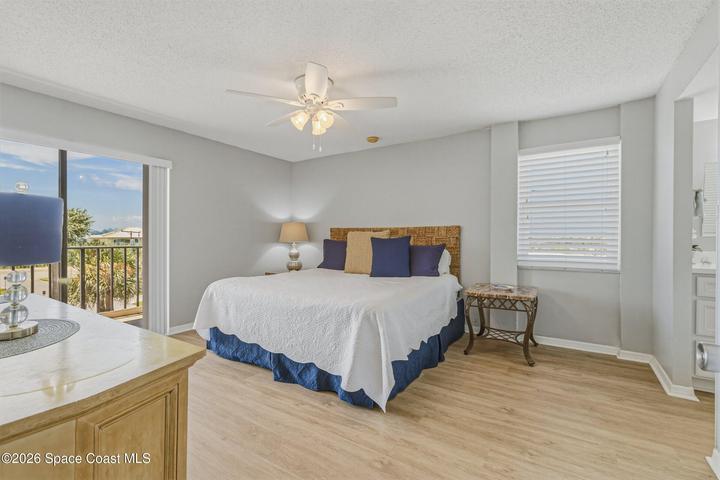 Primary bedroom with impact rated north facing window. The balcony has shutters.