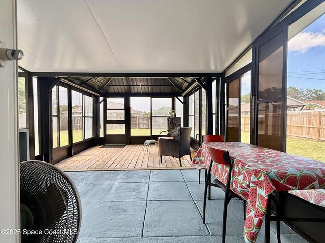 extended patio, covered and screened with a built in deck