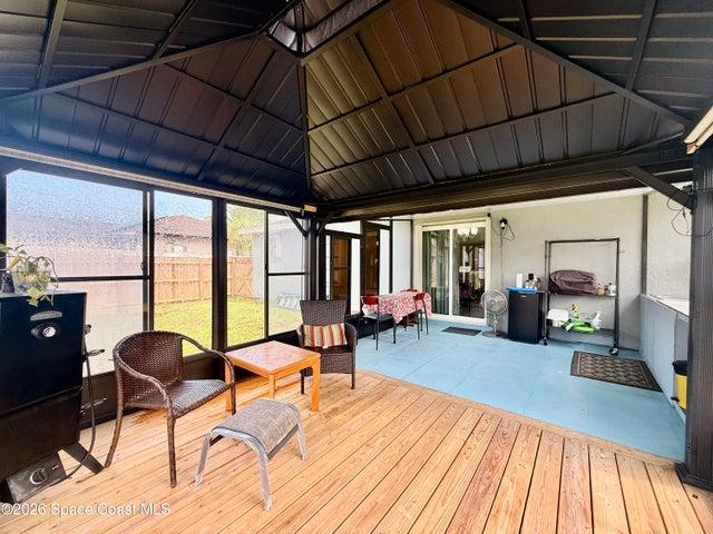 outdoor patio,summer kitchen with a built in deck, screened with pull down shades