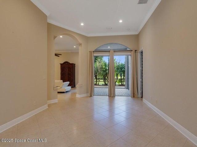 Living room featuring crown molding and recessed lighting