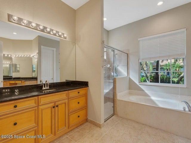 Full bath with a bath, vanity, a shower stall, light tile patterned floors, and recessed lighting