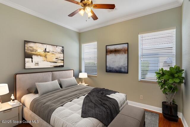 Bedroom featuring crown molding, wood finished floors, and ceiling fan