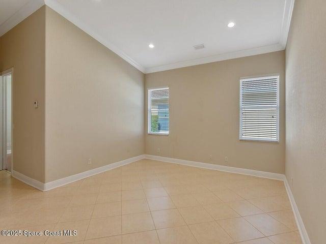 Spare room featuring crown molding and recessed lighting