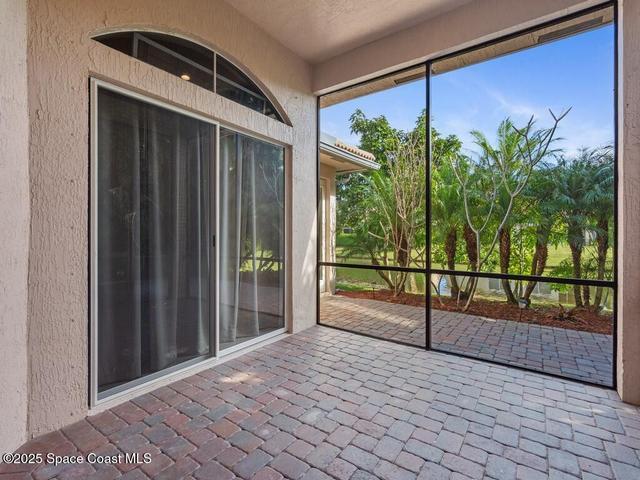 Sunroom / solarium featuring brick floors and a textured wall