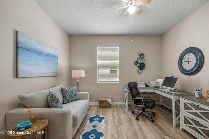 Versatile room featuring light-toned walls and wood-finish flooring