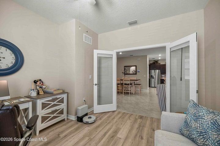 Versatile room featuring light-toned walls and wood-finish flooring