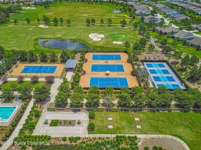 Multiple outdoor tennis courts, pickleball courts, and a covered viewing area