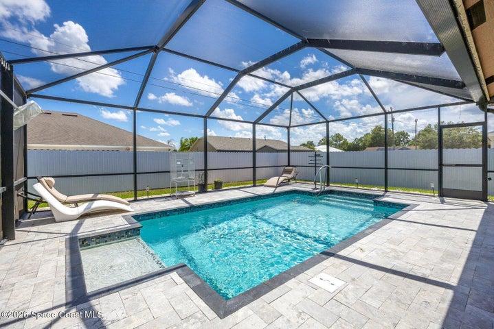 Enjoy Florida living in a private screened pool surrounded by an expansive paver deck and fully fenced backyard.