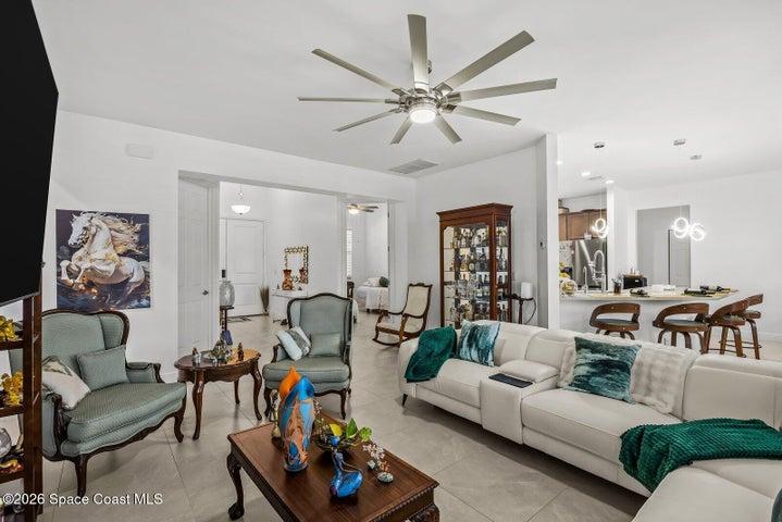 The open-floorplan creates a seamless flow between the kitchen, dining, and living areas, making everyday living comfortable and entertaining effortless. Natural light and volume ceilings enhance the home's bright, airy feel.