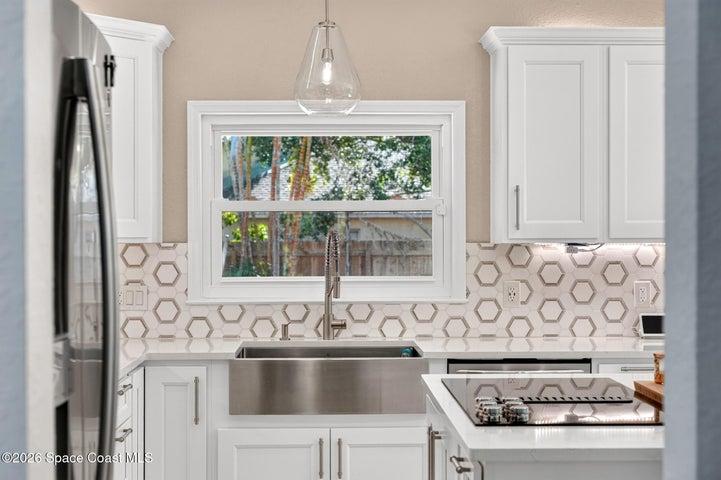 Farm sink with a pass through window to the outside built in cooking station.