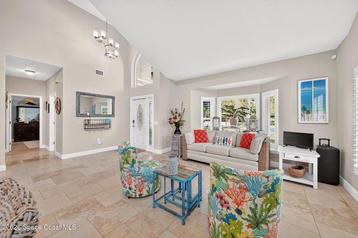 Spacious front room with vaulted ceilings with custom lighting.