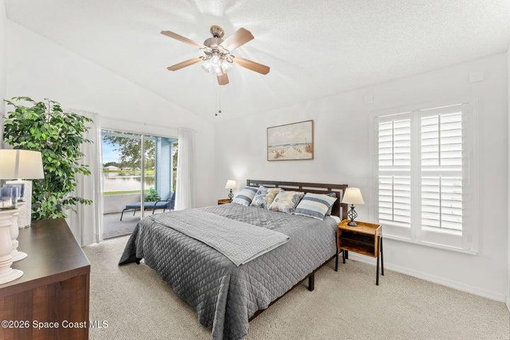 Primary bedroom features plantaion shutters and private lanai entrance