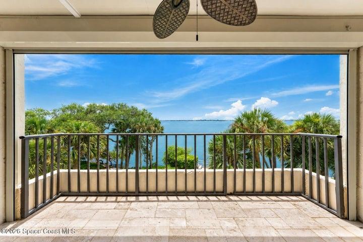 Covered balcony overlooking the Indian River Lagoon, boat launch and fishing pier at 3220 River Villa Way Unit 121.