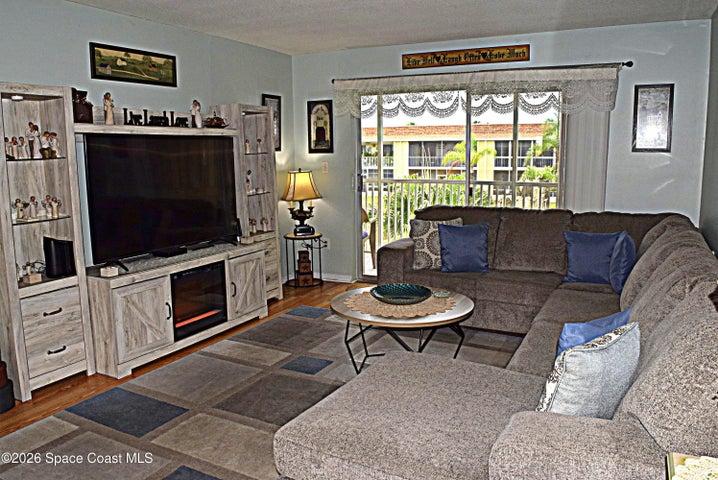Spacious Living Room adjoins the Balcony and overlooks the Courtyard beyond.