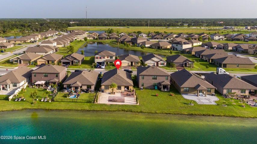 Aerial view highlighting the home’s direct lakefront location and surrounding Cypress Bay Preserve community.