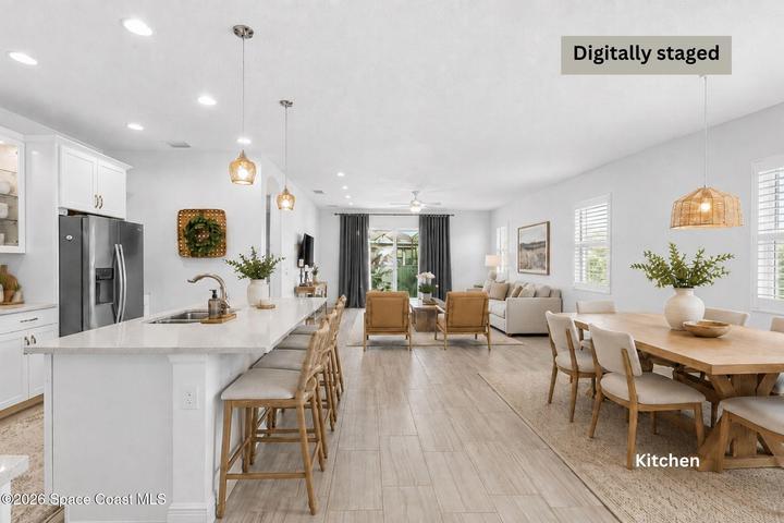Kitchen, dining, and living areas showcasing an open layout and modern design