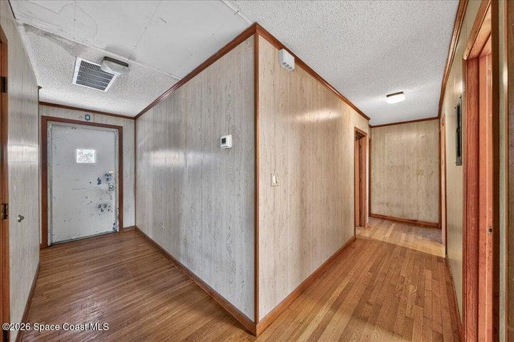 Front door to the left and hallway to the bedrooms on the right