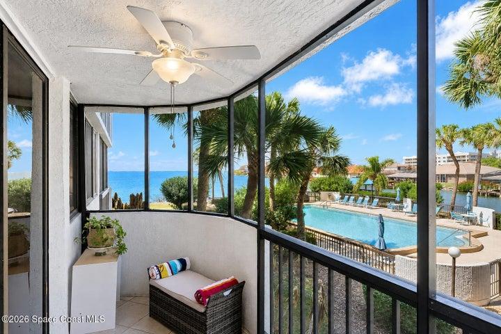 Screened balcony overlooking the canal, community pool and Banana River in Cape Canaveral.