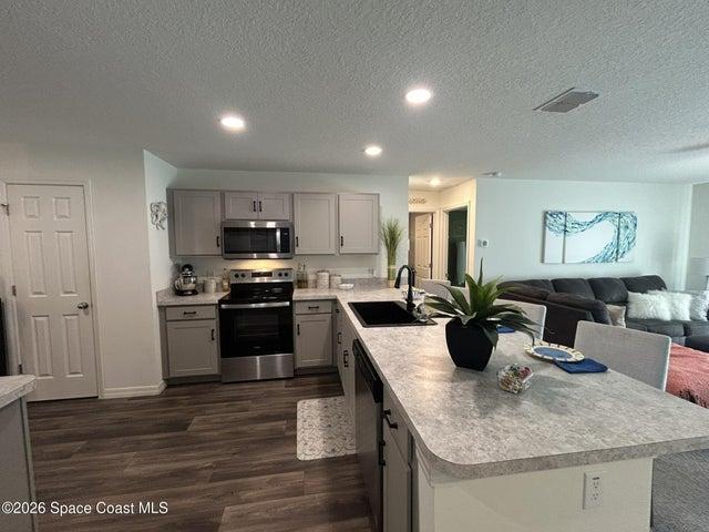 Kitchen view from hallway, open to Great Room and Dining Room.